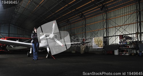 Image of young woman with private airplane