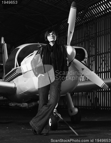 Image of young woman with private airplane