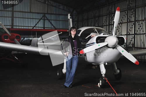 Image of young woman with private airplane