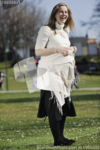 Image of happy young pregnant woman outdoor