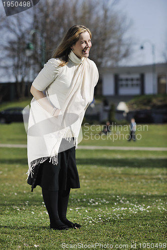 Image of happy young pregnant woman outdoor