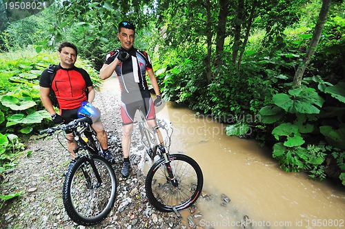 Image of friendship and travel on mountain bike