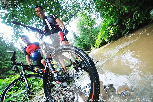 Image of friendship and travel on mountain bike