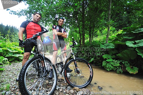 Image of friendship and travel on mountain bike