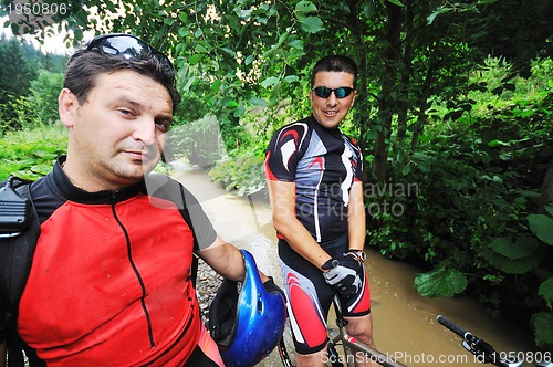 Image of friendship and travel on mountain bike