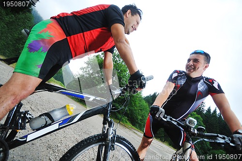 Image of friendship and travel on mountain bike