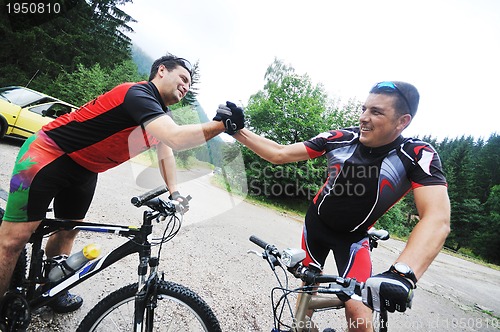 Image of friendship and travel on mountain bike