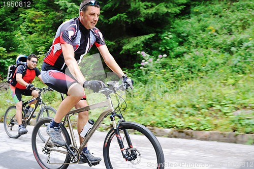 Image of friendship and travel on mountain bike