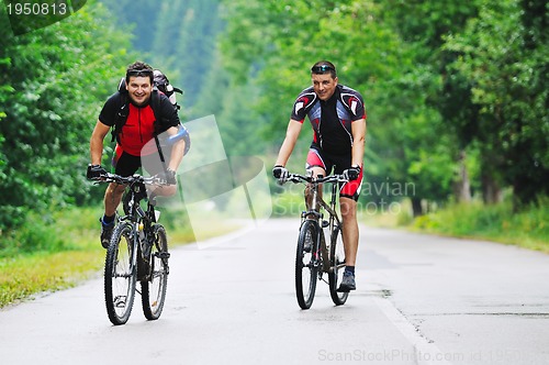 Image of friendship and travel on mountain bike