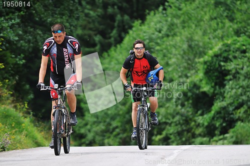 Image of friendship and travel on mountain bike