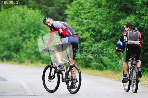 Image of friendship and travel on mountain bike