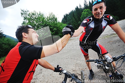 Image of friendship and travel on mountain bike