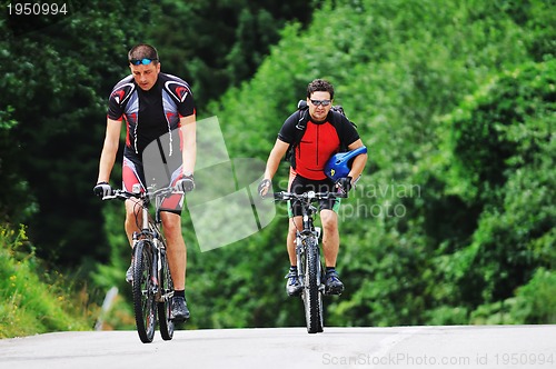Image of friendship and travel on mountain bike