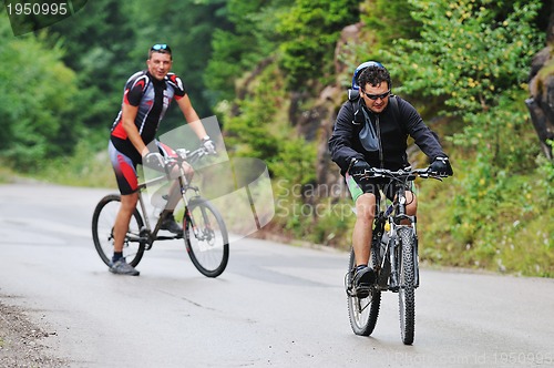 Image of friendship and travel on mountain bike