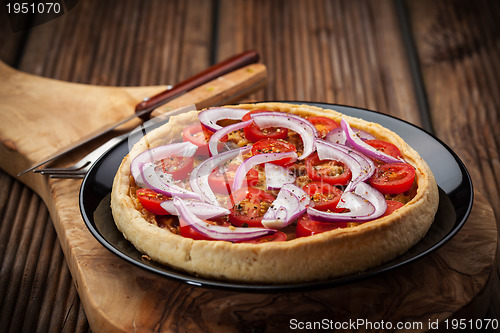 Image of Homemade onion quiche with tomatoes