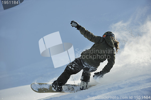 Image of freestyle snowboarder jump and ride