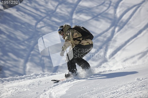 Image of freestyle snowboarder jump and ride