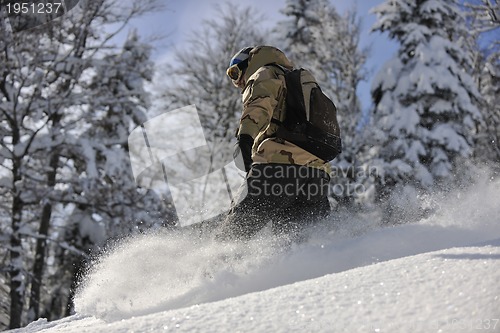 Image of freestyle snowboarder jump and ride