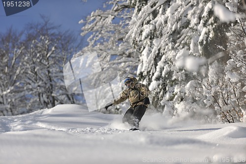 Image of freestyle snowboarder jump and ride