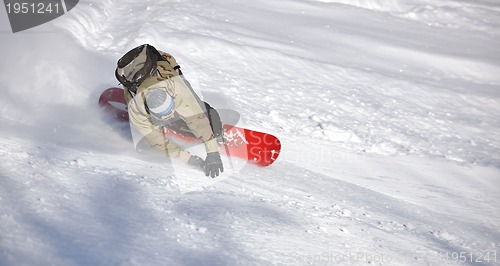 Image of freestyle snowboarder jump and ride