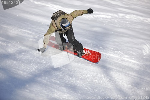 Image of freestyle snowboarder jump and ride