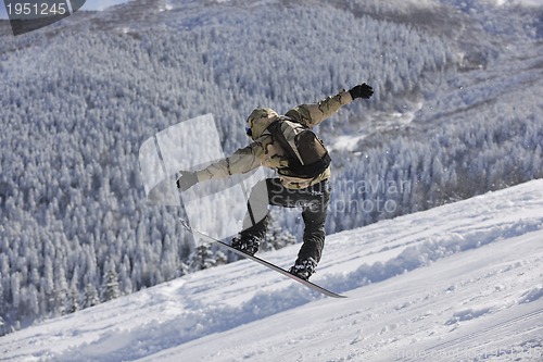 Image of freestyle snowboarder jump and ride