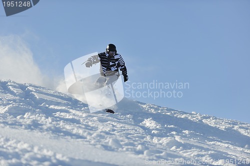 Image of freestyle snowboarder jump and ride