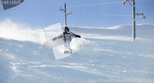 Image of freestyle snowboarder jump and ride