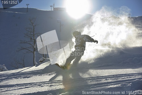 Image of freestyle snowboarder jump and ride