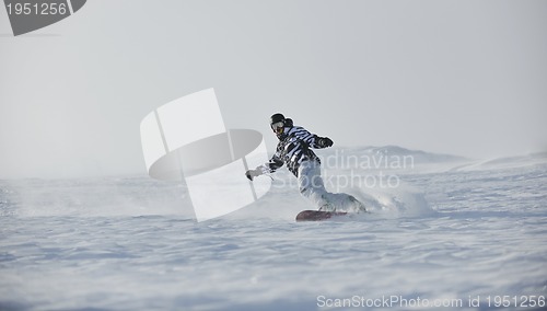 Image of freestyle snowboarder jump and ride