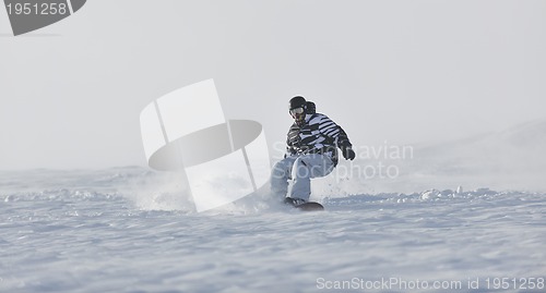 Image of freestyle snowboarder jump and ride