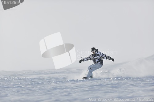 Image of freestyle snowboarder jump and ride