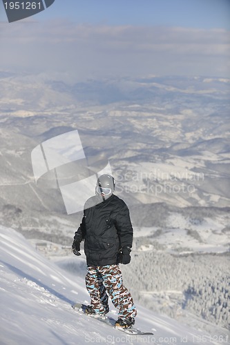 Image of freestyle snowboarder jump and ride