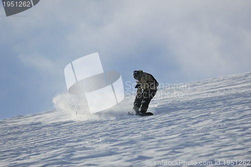 Image of freestyle snowboarder jump and ride