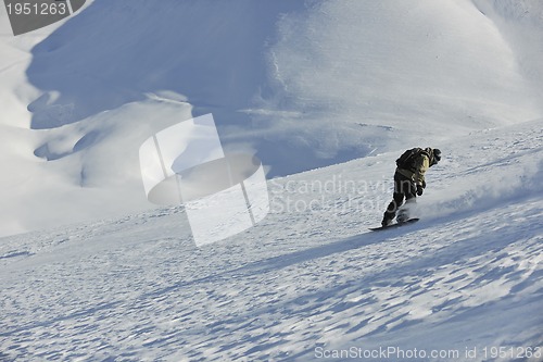 Image of freestyle snowboarder jump and ride