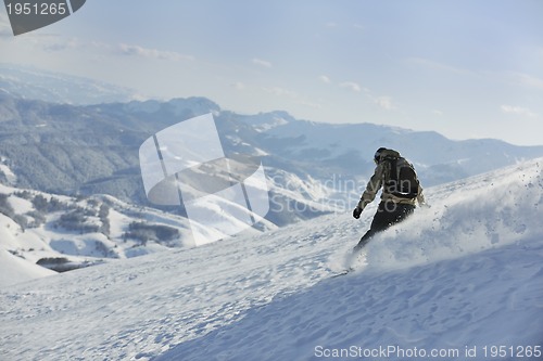 Image of freestyle snowboarder jump and ride