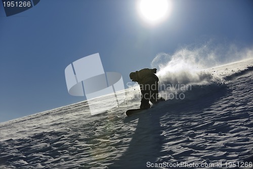 Image of freestyle snowboarder jump and ride