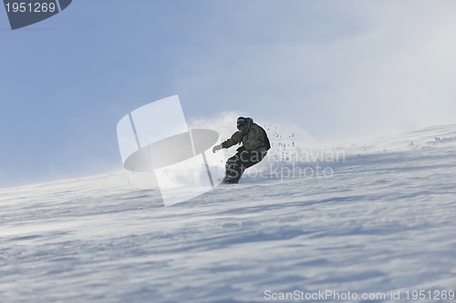 Image of freestyle snowboarder jump and ride