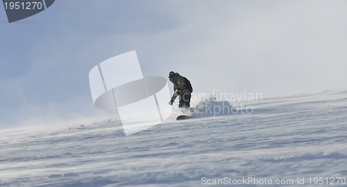 Image of freestyle snowboarder jump and ride