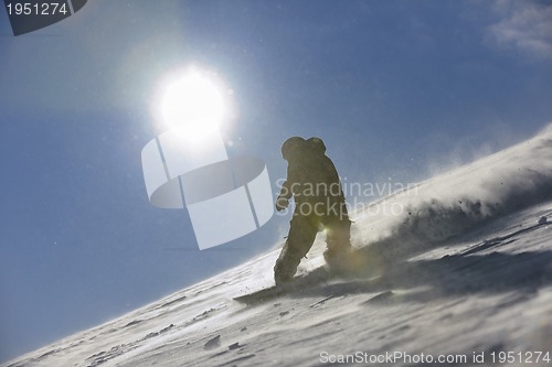 Image of freestyle snowboarder jump and ride