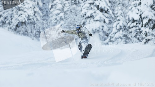 Image of freestyle snowboarder jump and ride