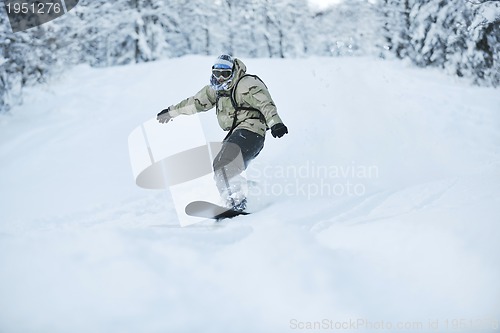 Image of freestyle snowboarder jump and ride
