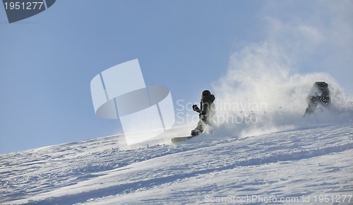 Image of freestyle snowboarder jump and ride