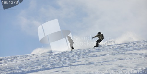 Image of freestyle snowboarder jump and ride