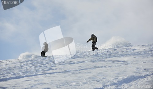 Image of freestyle snowboarder jump and ride