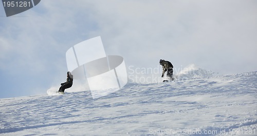 Image of freestyle snowboarder jump and ride