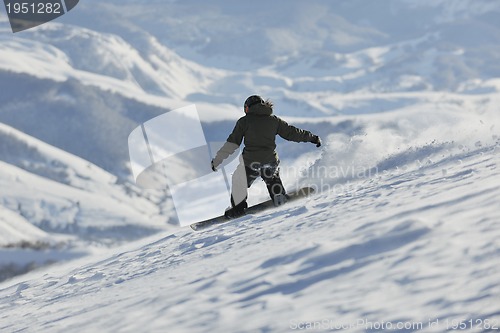 Image of freestyle snowboarder jump and ride