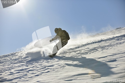 Image of freestyle snowboarder jump and ride