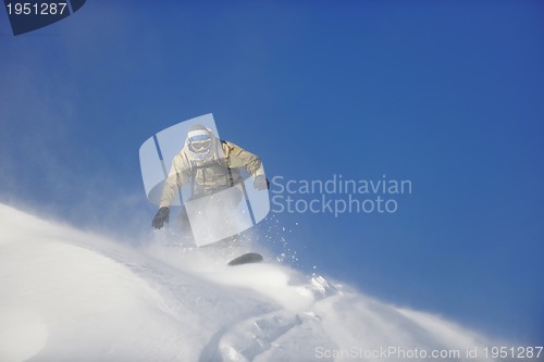 Image of freestyle snowboarder jump and ride