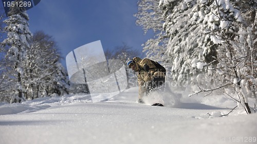 Image of freestyle snowboarder jump and ride